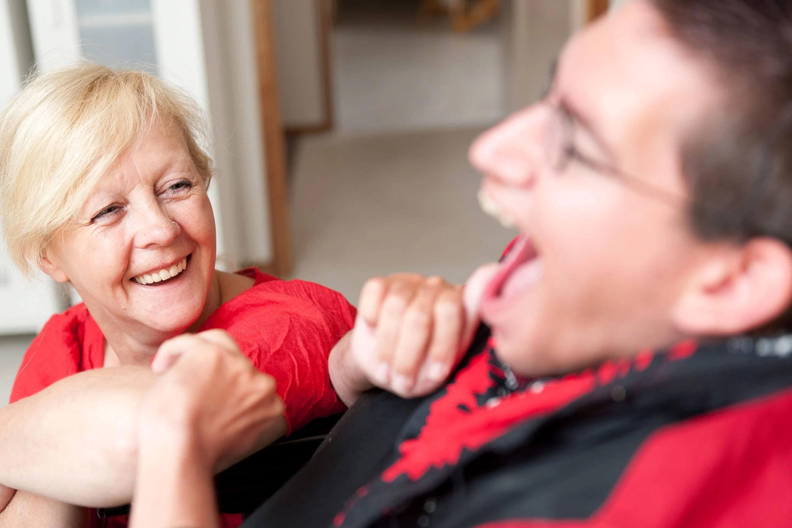 woman smiling at boy w developmental disabilities scaled